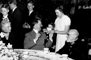 A New Yorker cartoon from the late 1930s shows two cowering men in an empty banquet hall, nervously regarding a third man who stands proudly oblivious, tea cup in hand. The caption reads: "The Messrs Houghton and Mifflin tender a tea to one of their authors". The man in the centre is Adolf Hitler, author of Mein Kampf, one of Hougton and Mifflin's bestsellers.  