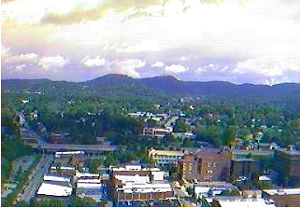 Webcam located in downtown Asheville looking north towards Mt. Mitchell and the Black Mountains.  Other sites to the north would include the town of Weaverville, Mars Hill, Burnsville, The Grove Park Inn, and the Blue Ridge Parkway, which winds its way around Asheville from the north, then east, south, and west towards Brevard, where it passes the highest point on the Parkway allowing views of Cold Mountain and the Smoky Mountains.  The Parkway ends near Harrah's Casino. 