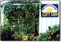 The Madison County Craft Co-op shares space with the Yellow Teapot  gift and tea shop, which sells over 60 varieties of tea plus tea accessories, and serves hot and iced tea  out on the vine-shaded porch of  this unique  century-old house.     