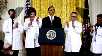 U.S. President Barack Obama shakes hands with his healthcare worker props after speaking about healthcare reform.  